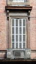 Vintage rustic ventilated closed wooden window shutters in brick Royalty Free Stock Photo