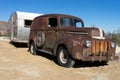 Vintage rusty car and trailer in the desert
