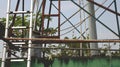 Vintage Rusty Clothes Rack with Old Metal Ladders over Dirty Green Wall