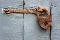 Vintage rusty locked padlock on a wooden door