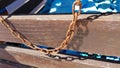 Weathered rusty metal chain hanging on old wooden background Royalty Free Stock Photo