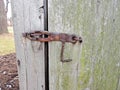 Vintage historic handmade rusty iron metal latch hook on barn door Royalty Free Stock Photo