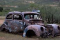 Vintage rusty old abandoned car decaying on a rural field Royalty Free Stock Photo