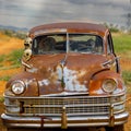 Vintage rusty old abandoned car decorated with skeletons decaying on a rural field Royalty Free Stock Photo