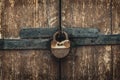 Vintage rusty padlock on old weathered wooden gates Royalty Free Stock Photo