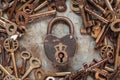 Vintage rusty padlock surrounded by old keys