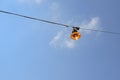 Vintage rusty street light lit on the wire on day