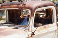 an old rusty truck sitting in a field near other rusting vehicles Royalty Free Stock Photo