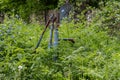 Vintage rusty water fountain hand pump in russian village. Abandoned water wellhead Royalty Free Stock Photo