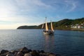 Vintage sailing-boat leaving port at sunset Royalty Free Stock Photo