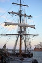 Furl the sails on sailing ship by dusk in harbor city Sydney