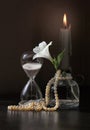 Vintage sandglass and flower