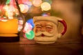 Vintage Santa mug in front of the Christmas tree Royalty Free Stock Photo