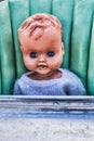 Vintage Creepy Doll Sitting in An Old Baby High Chair