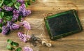 Vintage school slate with fresh lilac blooms Royalty Free Stock Photo