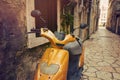 Vintage scooter in narrow street in Mediterranean town