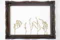 vintage sculpted wood frame with dried flower twigs