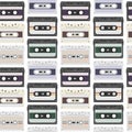 Vintage seamless pattern with analogue music cassettes. 80s Loopable background with magnetic audio tapes Royalty Free Stock Photo