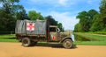Vintage Second World War truck with red cross signs parked with Wrest Park House in background