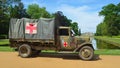 Vintage Second World War truck with red cross signs parked with Wrest Park House in background