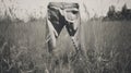 Vintage Sepia-toned Jeans Hanging In Tall Grass