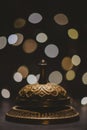 Vintage service bell with bokeh on dark backround