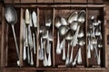 Vintage service cutlery inside a rustic wooden box