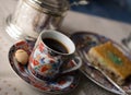 Vintage set of beautiful painted cup of coffee, honey cake Baklava and sugar bowl. Selective focus Royalty Free Stock Photo