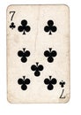A vintage seven of clubs playing card.