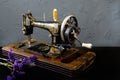 Vintage sewing machine is standing on the white table