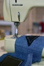 Vintage sewing machine close up with jeans. Hobbies and leisure. Royalty Free Stock Photo