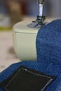 Vintage sewing machine close up with jeans. Hobbies and leisure. Royalty Free Stock Photo