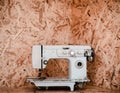 Vintage Sewing machine on flakeboard background Royalty Free Stock Photo