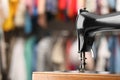 Vintage sewing machine with thread on blurred background, closeup. Space for text Royalty Free Stock Photo