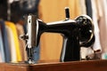 Vintage sewing machine with thread in workshop, closeup Royalty Free Stock Photo