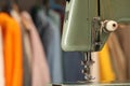 Vintage sewing machine with thread in workshop, closeup. Space for text Royalty Free Stock Photo