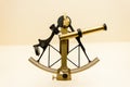 Vintage Sextant and Astrolabe isolated on smooth coral background