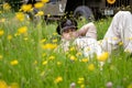 Handsome American WWII GI Army Officer In Uniform Relaxes In A Meadow Of Flowers In Front Of Willy Jeep