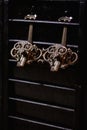 vintage shabby bronze hooks on a dark background in a vintage interior Royalty Free Stock Photo