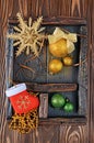 Vintage shadow box with golden and green christmas ball on wood background Royalty Free Stock Photo