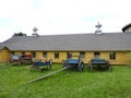 Vintage Shaker Farm wagons in front of yellow barn