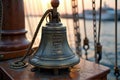 Vintage ship bell with engraved text on nautical vessel during sunset Royalty Free Stock Photo