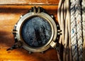 Vintage ship brass porthole and ropes Royalty Free Stock Photo