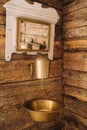 Vintage shot of an old metal washbasin and mirror in a wooden house in the village