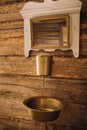 Vintage shot of an old metal washbasin and mirror in a wooden house in the village