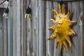 Vintage shot of a sun-shaped decoration on a wooden wall