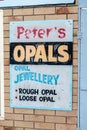 A vintage sign for opal store on the wall of a building in Lightning Ridge