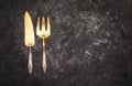 Vintage silver brass cutlery fish set of knife and fork on dark background