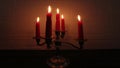 Vintage silver candlestick with burning red candles.1