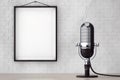 Vintage Silver Microphone in front of Brick Wall with Blank Frame Royalty Free Stock Photo